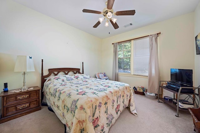 carpeted bedroom with ceiling fan and visible vents