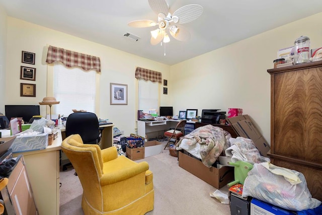 office area featuring carpet floors, a ceiling fan, and visible vents