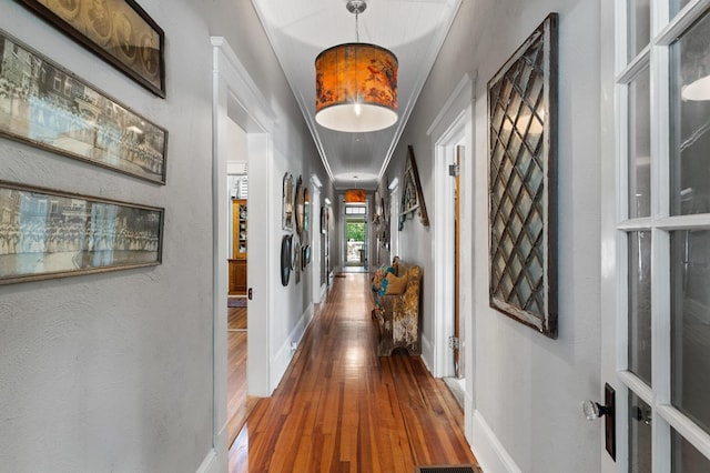 17779 Main St, Woodbury, GA 30293 - corridor featuring wood-type flooring, baseboards, ornamental molding, and attic access