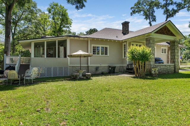 17779 Main St, Woodbury, GA 30293 - back of house with a sunroom, a lawn, a chimney, and a shingled roof