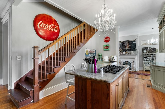 17779 Main St, Woodbury, GA 30293 - kitchen with a chandelier, light wood finished floors, baseboards, and crown molding