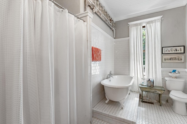 17779 Main St, Woodbury, GA 30293 - full bath with tile walls, toilet, a freestanding bath, and wainscoting