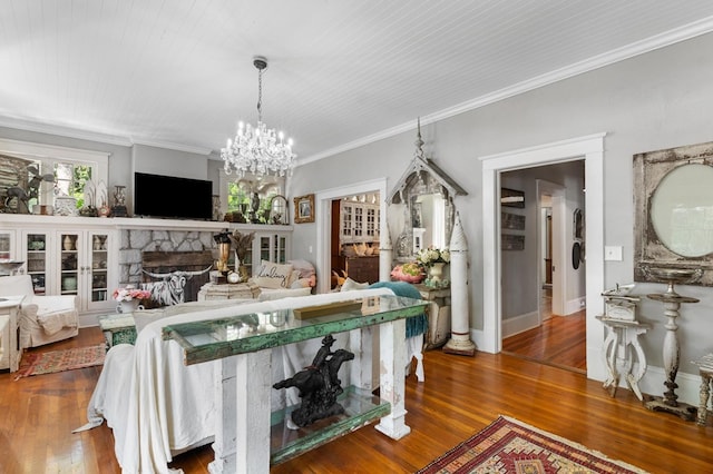 17779 Main St, Woodbury, GA 30293 - living room with wood finished floors, ornamental molding, a chandelier, and a stone fireplace