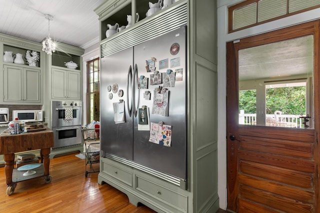 17779 Main St, Woodbury, GA 30293 - kitchen with stainless steel appliances, open shelves, light wood-style flooring, pendant lighting, and a chandelier