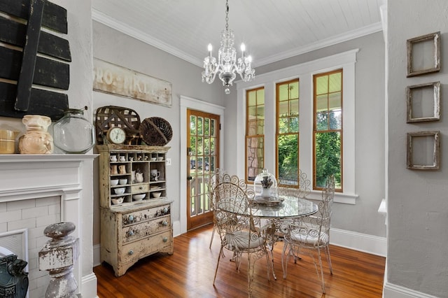 17779 Main St, Woodbury, GA 30293 - dining area with a chandelier, wood finished floors, crown molding, baseboards, and a fireplace