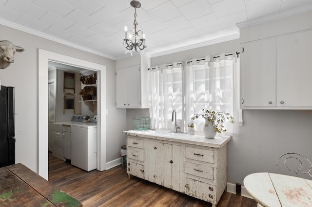 17779 Main St, Woodbury, GA 30293 - laundry room with crown molding, dark wood-style floors, and a chandelier