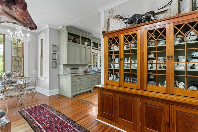 17779 Main St, Woodbury, GA 30293 - dining room featuring a chandelier, baseboards, light wood-type flooring, plenty of natural light, and crown molding