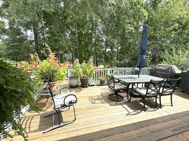 4804 Champions Way, Columbus, GA 31909 - wooden deck with outdoor dining space, area for grilling, and view of wooded area