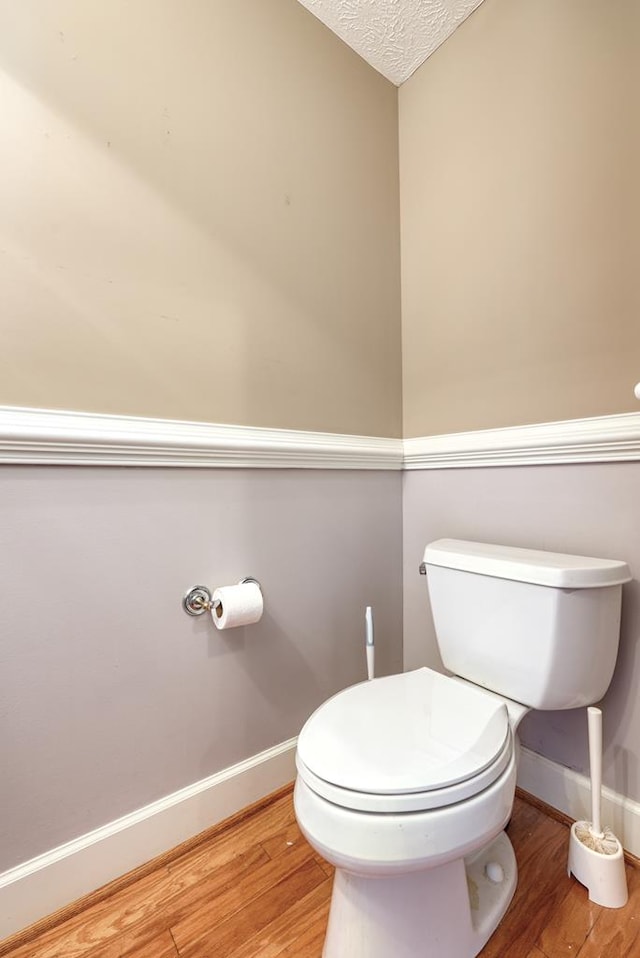 4589 Carnoustie Ln, Columbus, GA 31909 - bathroom featuring baseboards, wood finished floors, toilet, and a textured ceiling