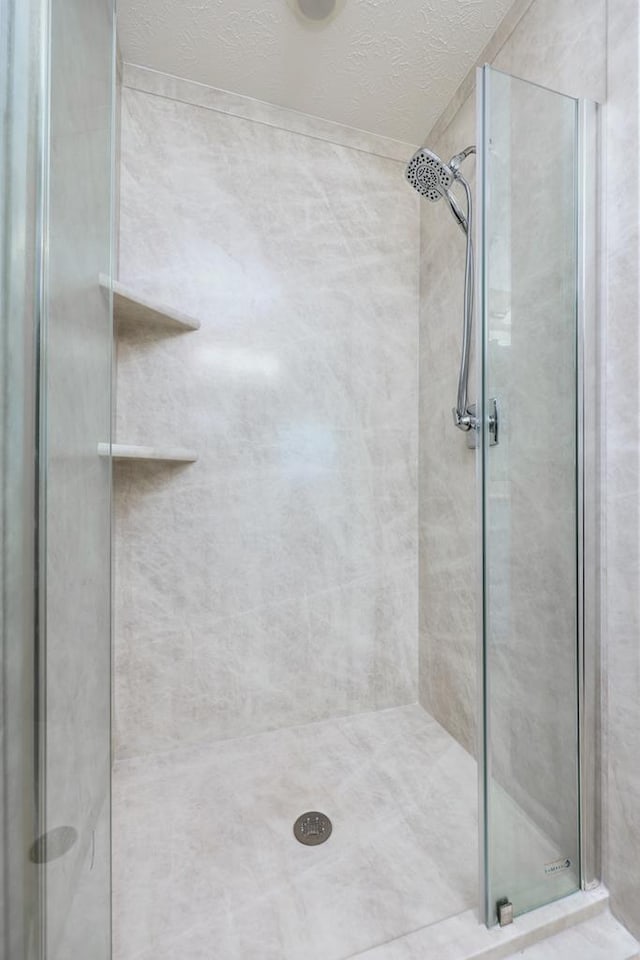 4589 Carnoustie Ln, Columbus, GA 31909 - bathroom with a shower stall and a textured ceiling