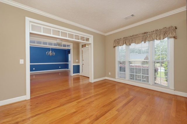 4589 Carnoustie Ln, Columbus, GA 31909 - empty room featuring wood finished floors, a chandelier, ornamental molding, baseboards, and a textured ceiling