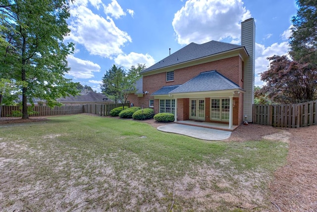 4589 Carnoustie Ln, Columbus, GA 31909 - rear view of house featuring french doors, a chimney, a patio area, brick siding, and a shingled roof
