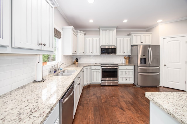 6027 Wellesley Dr, Columbus, GA 31904 - kitchen with appliances with stainless steel finishes, a sink, ornamental molding, dark wood-style floors, and backsplash