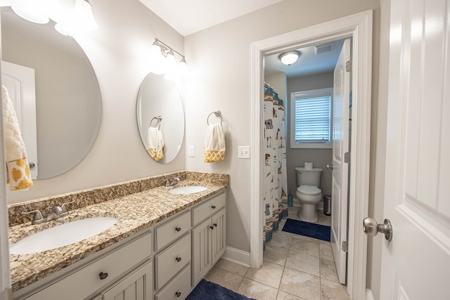 6027 Wellesley Dr, Columbus, GA 31904 - full bathroom featuring double vanity, baseboards, toilet, and tile patterned floors