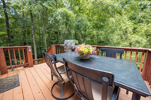 6027 Wellesley Dr, Columbus, GA 31904 - wooden terrace with outdoor dining space, area for grilling, and a forest view