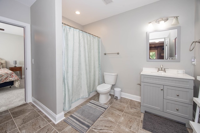 6027 Wellesley Dr, Columbus, GA 31904 - full bathroom with vanity, toilet, ensuite bathroom, baseboards, and a shower with shower curtain