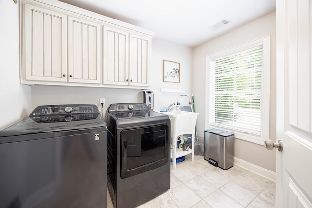 6027 Wellesley Dr, Columbus, GA 31904 - laundry room featuring washing machine and dryer, cabinet space, and baseboards