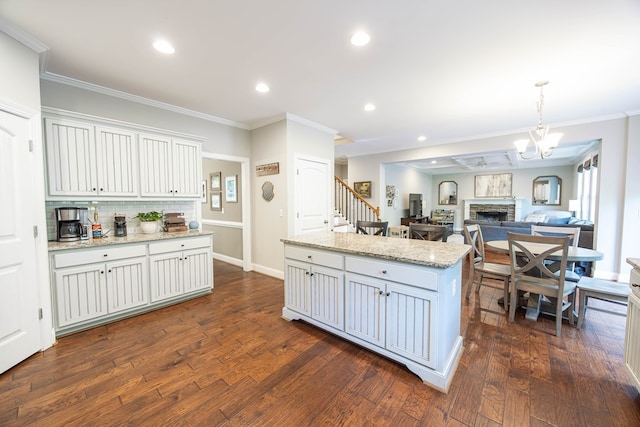 6027 Wellesley Dr, Columbus, GA 31904 - kitchen with tasteful backsplash, a kitchen island, ornamental molding, dark wood-style floors, and recessed lighting