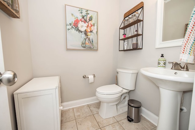 6027 Wellesley Dr, Columbus, GA 31904 - half bathroom with baseboards, toilet, tile patterned floors, and a sink