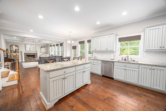 6027 Wellesley Dr, Columbus, GA 31904 - kitchen featuring dishwasher, a center island, a sink, decorative backsplash, and crown molding