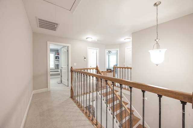 6027 Wellesley Dr, Columbus, GA 31904 - hallway featuring an upstairs landing, attic access, baseboards, and light carpet