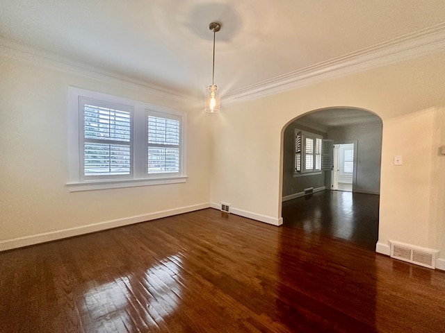 unfurnished room with dark wood-type flooring, a wealth of natural light, and ornamental molding