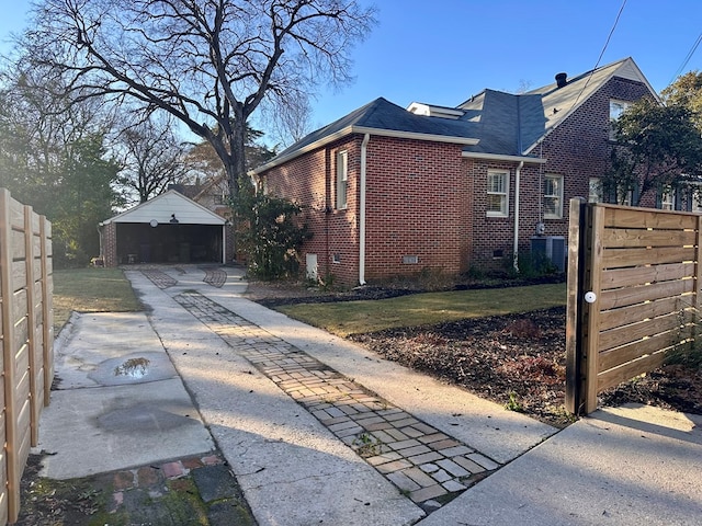 view of home's exterior with a garage and an outbuilding