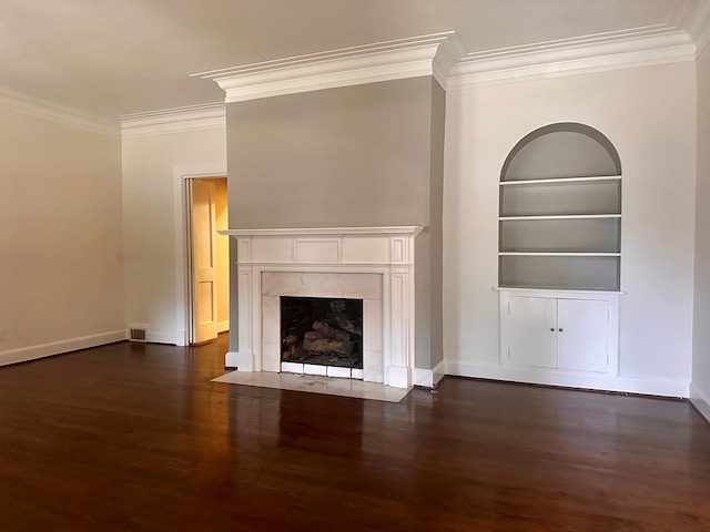 unfurnished living room featuring built in features, ornamental molding, and a premium fireplace