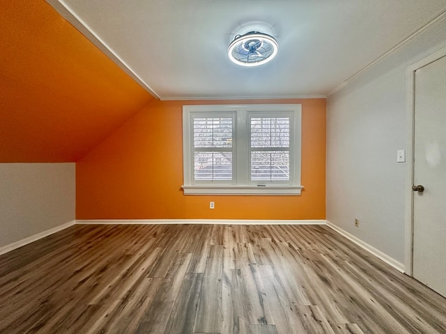 additional living space with vaulted ceiling and hardwood / wood-style floors