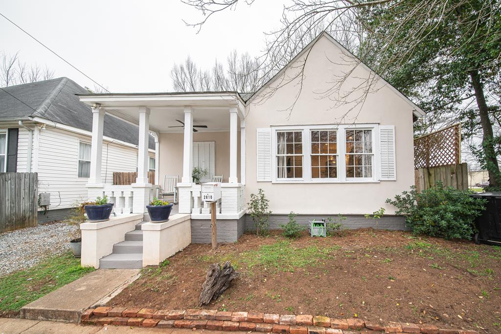 view of front of property with a porch, ceiling fan, and fence