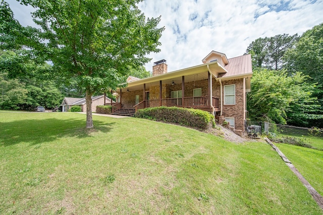 5604 Holland Dr, Columbus, GA 31909 - ranch-style home with brick siding, covered porch, a chimney, and metal roof