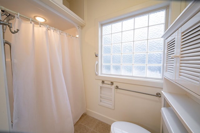 5604 Holland Dr, Columbus, GA 31909 - bathroom featuring tile patterned floors, toilet, curtained shower, and baseboards