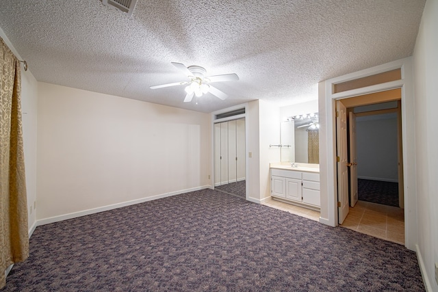 5604 Holland Dr, Columbus, GA 31909 - unfurnished bedroom featuring carpet floors, a closet, a textured ceiling, ceiling fan, and a sink