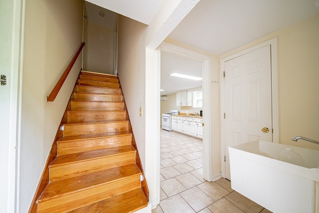 5604 Holland Dr, Columbus, GA 31909 - staircase with tile patterned floors and baseboards