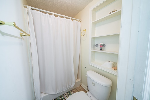 5604 Holland Dr, Columbus, GA 31909 - bathroom featuring a textured ceiling, toilet, a shower with shower curtain, and tile patterned flooring
