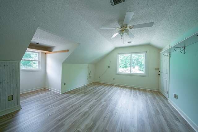 5604 Holland Dr, Columbus, GA 31909 - additional living space with a textured ceiling, vaulted ceiling, wood finished floors, a ceiling fan, and baseboards