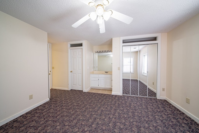 5604 Holland Dr, Columbus, GA 31909 - unfurnished bedroom with carpet, a textured ceiling, baseboards, a ceiling fan, and a sink