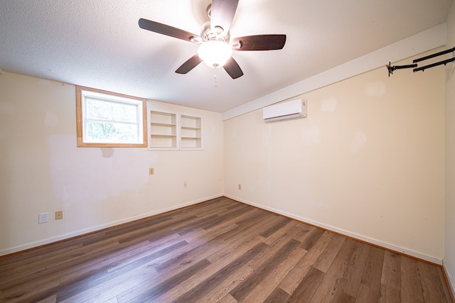 5604 Holland Dr, Columbus, GA 31909 - empty room with an AC wall unit, wood finished floors, baseboards, a ceiling fan, and a textured ceiling