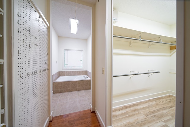 5604 Holland Dr, Columbus, GA 31909 - bathroom with wood finished floors, a bath, and a spacious closet