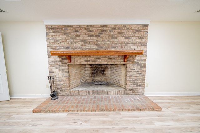 5604 Holland Dr, Columbus, GA 31909 - detailed view of a brick fireplace, wood finished floors, and baseboards