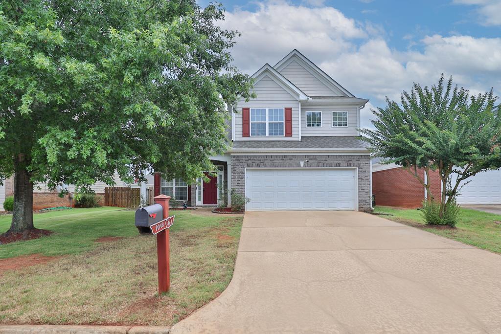 9048 Sante Fe Ct, Columbus, GA 31909 - view of front of home featuring an attached garage, concrete driveway, and brick siding