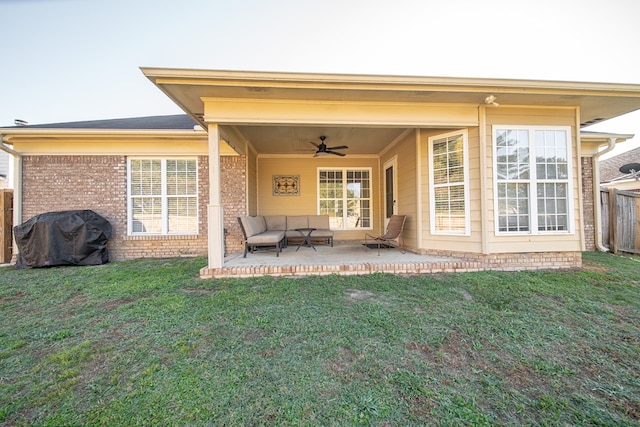 rear view of house with a yard, a patio, and ceiling fan