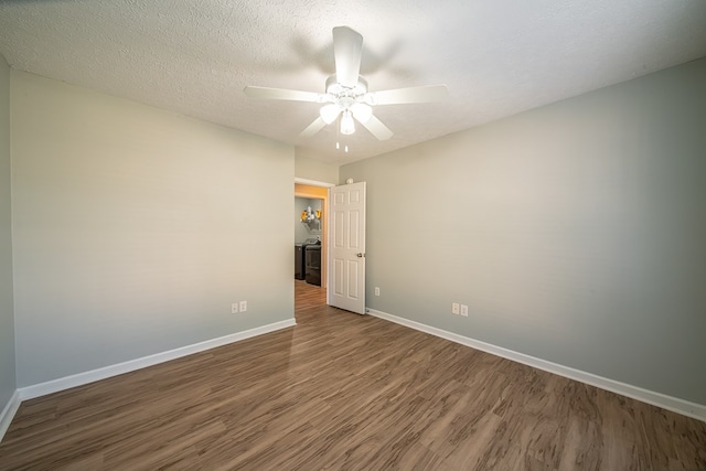 unfurnished room featuring ceiling fan, dark wood-type flooring, and a textured ceiling