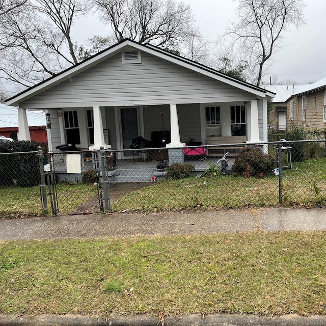 bungalow-style house with covered porch and a front yard