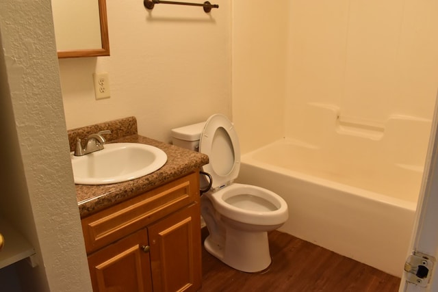 full bathroom with vanity, toilet, wood-type flooring, and bathtub / shower combination