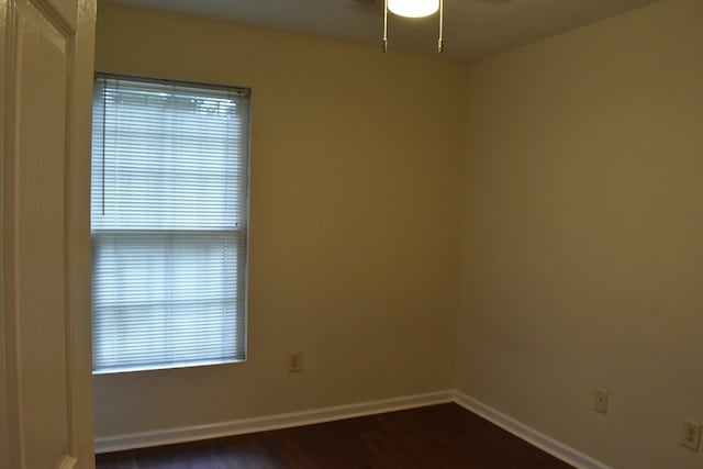 spare room with ceiling fan and dark wood-type flooring