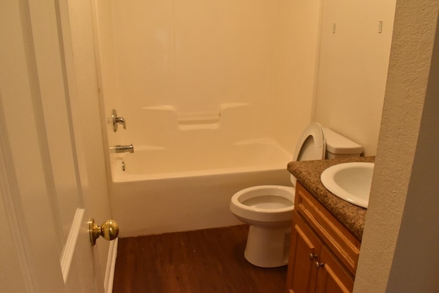 full bathroom featuring shower / washtub combination, hardwood / wood-style floors, vanity, and toilet