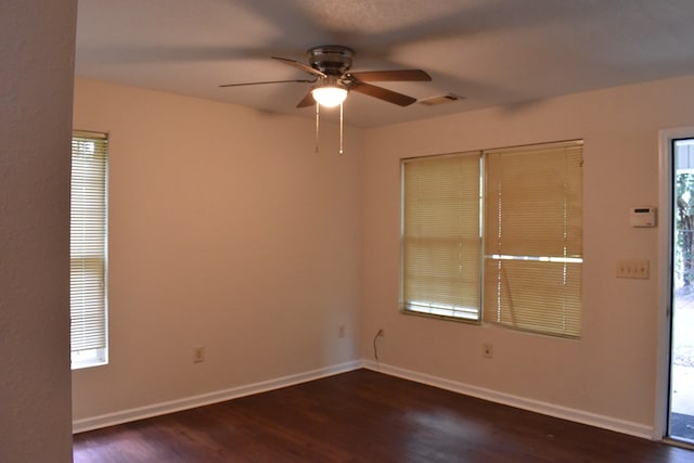 unfurnished room featuring ceiling fan and dark hardwood / wood-style flooring