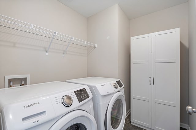 washroom with washing machine and dryer and cabinets