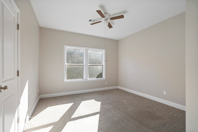 carpeted spare room featuring ceiling fan